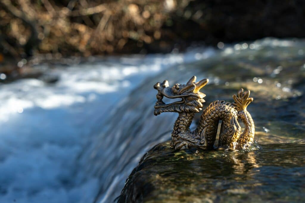 Golden Chinese Dragon Statue At The End Of A Waterfall