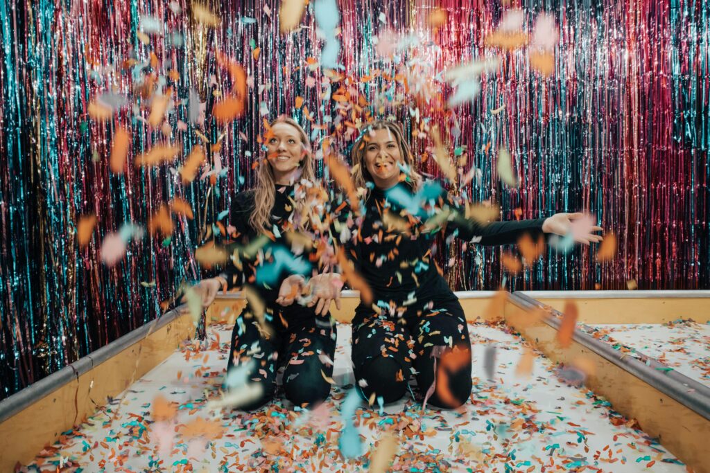 Photo by Designecologist: https://www.pexels.com/photo/two-women-kneeling-while-throwing-confetti-1627935/