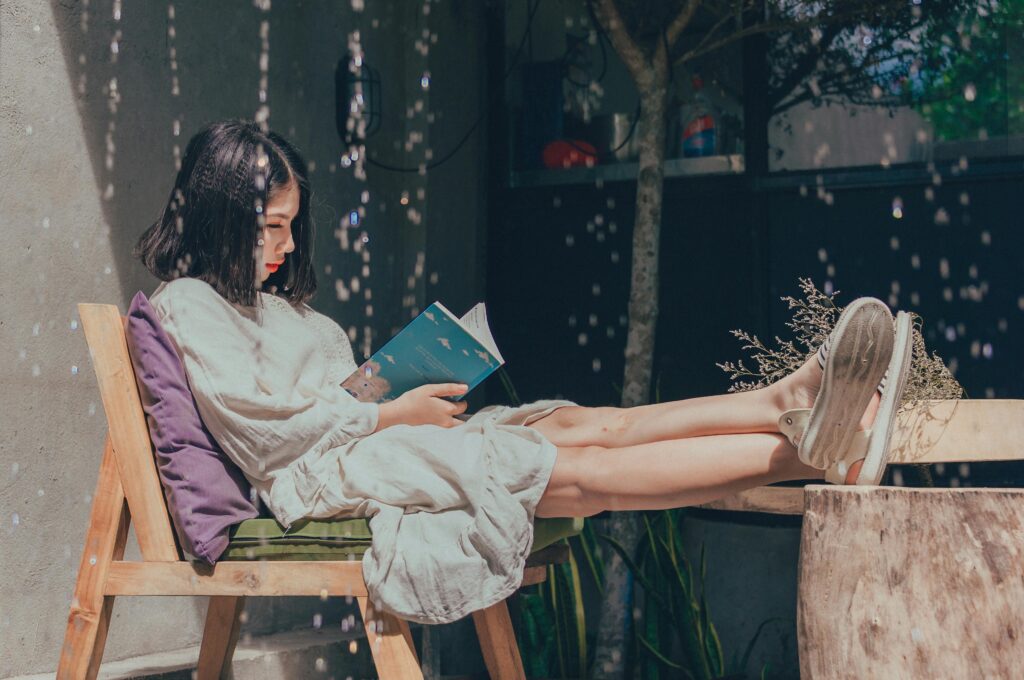 Photo by Min An: https://www.pexels.com/photo/woman-sitting-on-chair-while-reading-book-1115692/