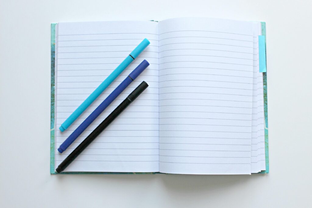 Photo by Pixabay: https://www.pexels.com/photo/opened-notebook-with-three-assorted-color-pens-236111/