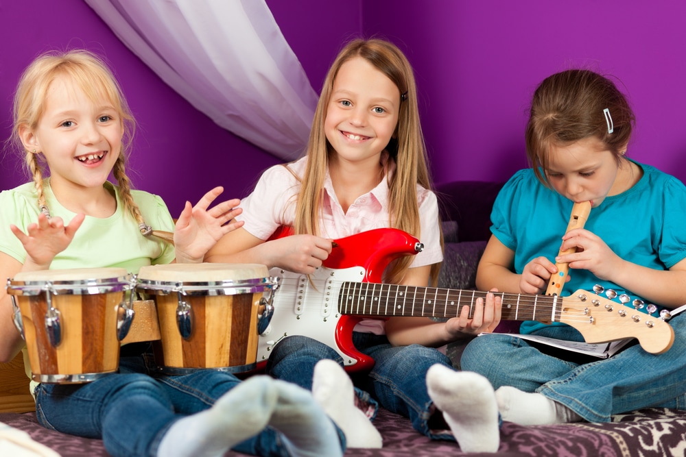 three-young-girls-playing-musical-instruments