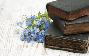 old-books-and-blue-flowers-on-wooden-table