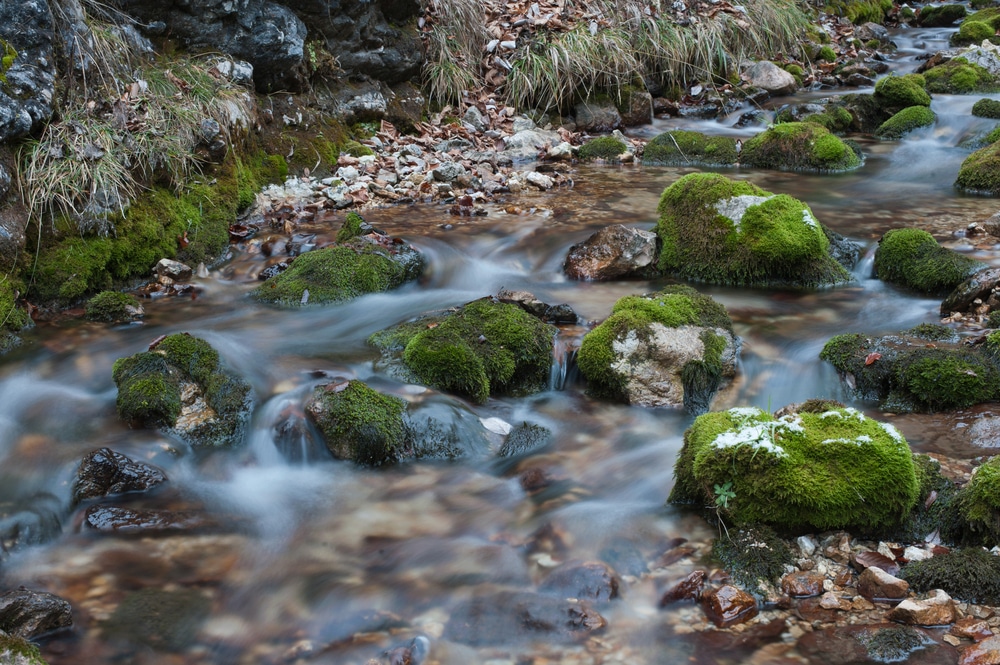 shot-of-water-flowing-through-rocks-in-river