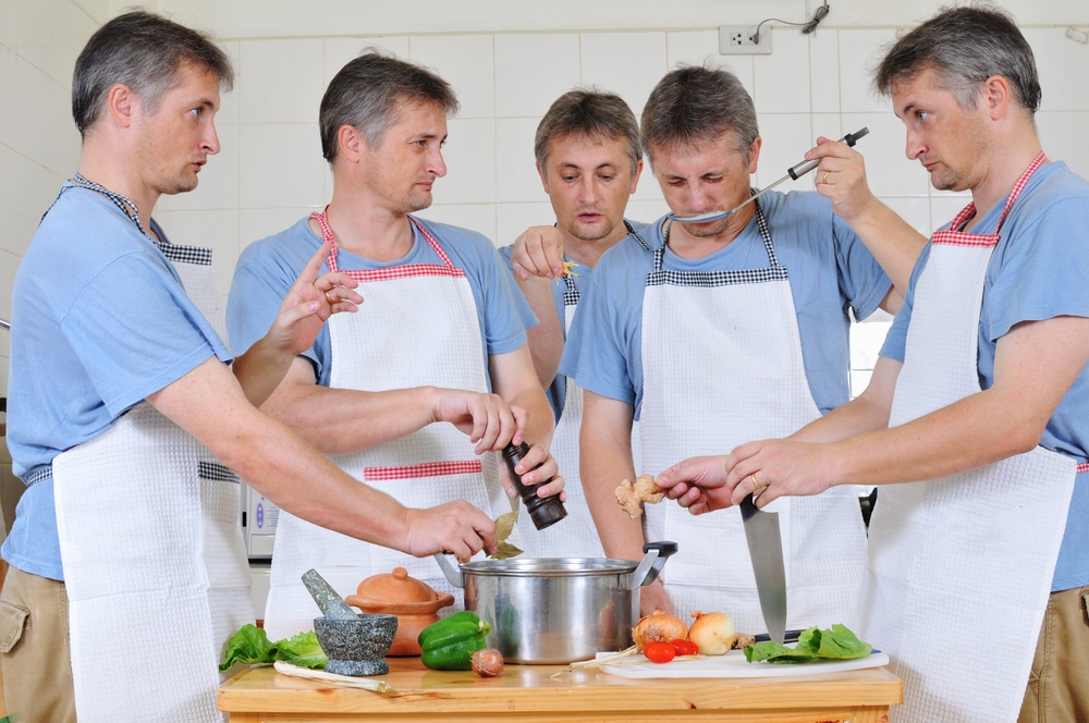 five-men-in-aprons-cooking-in-the-kitchen