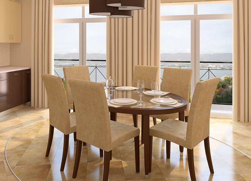a-set-dining-table-in-the-center-of-a-room-next-to-windows-overlooking-the-sea