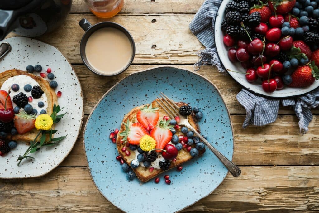 Toast with fresh fruit and yogurt laid out on a table