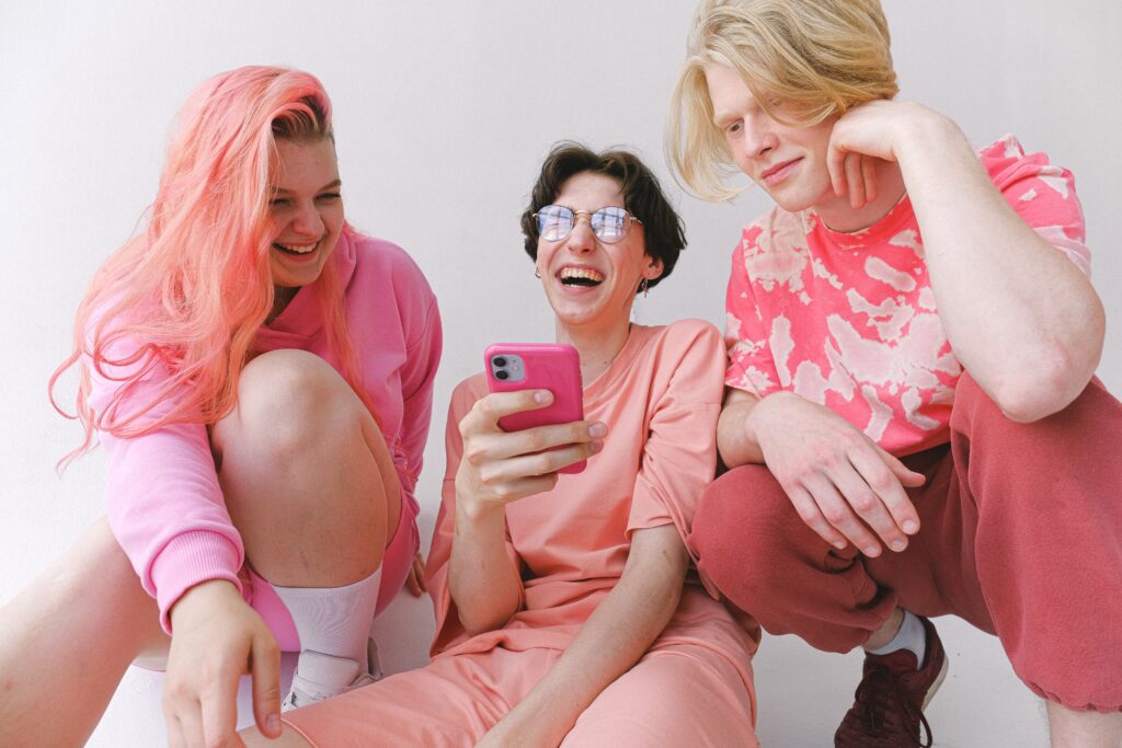 Three women holding a conversation on the phone