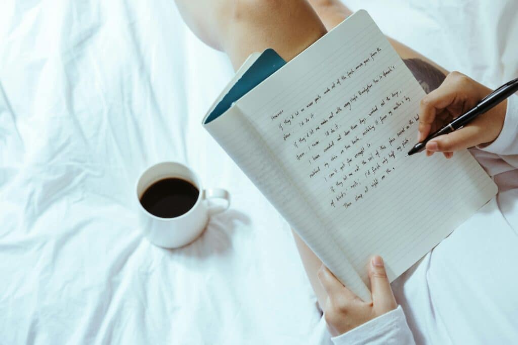 Photo by Ketut Subiyanto: https://www.pexels.com/photo/crop-woman-with-coffee-writing-in-notebook-on-bed-4132326/
