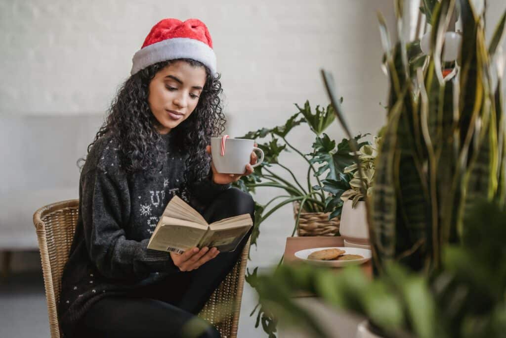 women-in-santa-hat-reading-book