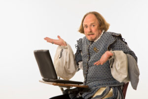 Shakespearean man confused in front of a laptop