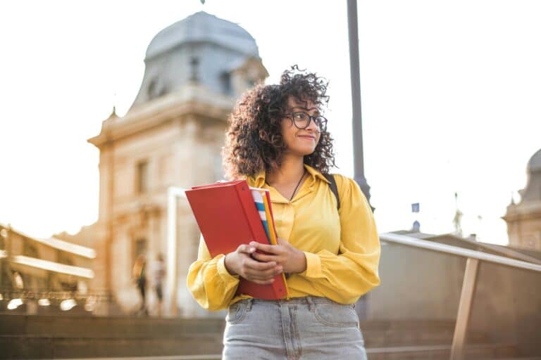 young-woman-holding-books-and-folders