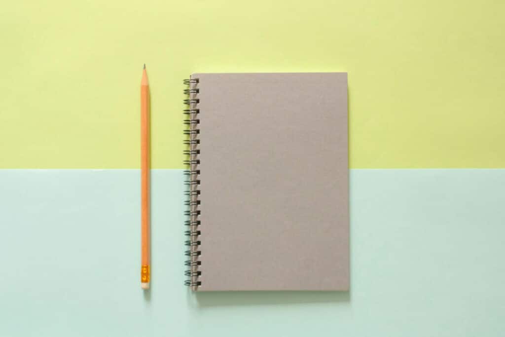 Notebook and a pen on a colorful background