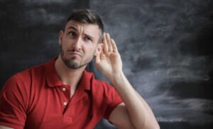 man holding hand by his ear