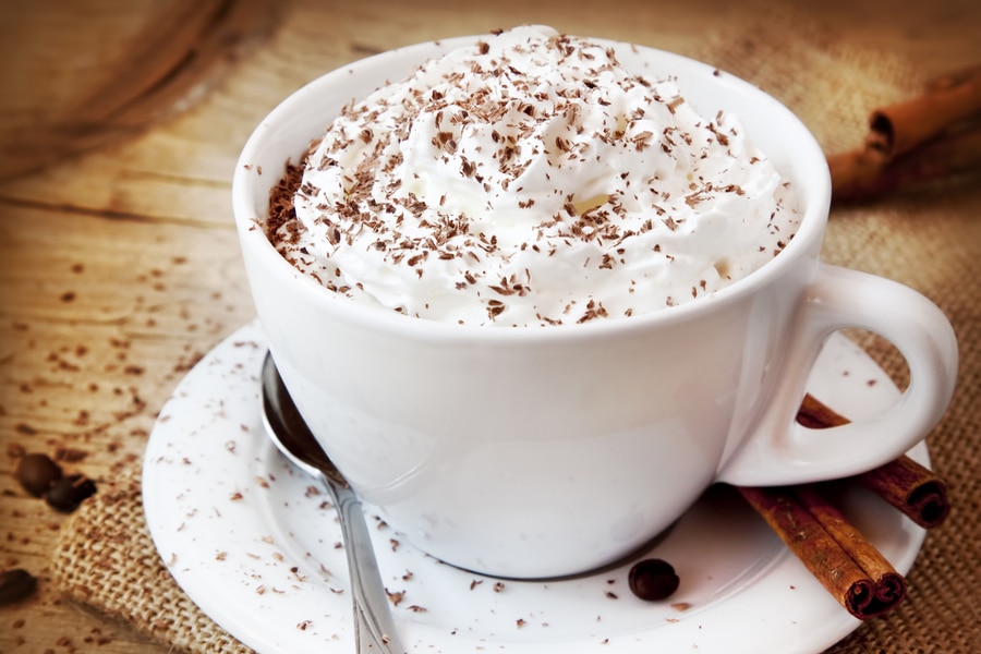 a cup of hot mocha with whipped cream and chocolate shavings