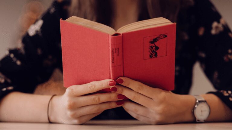 person holding a red book open