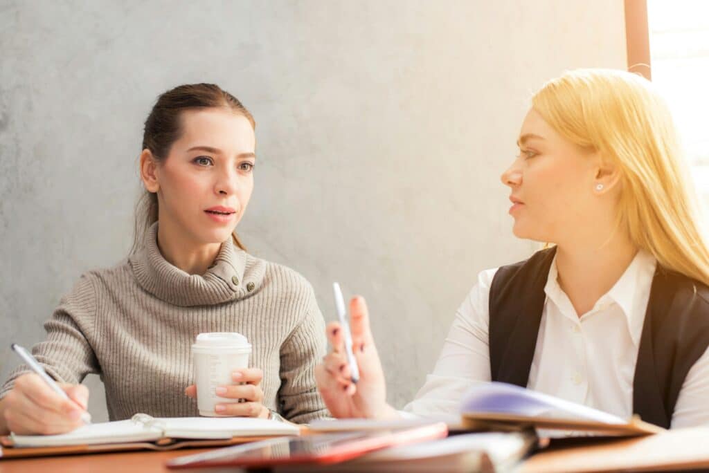 Two women talking at a table