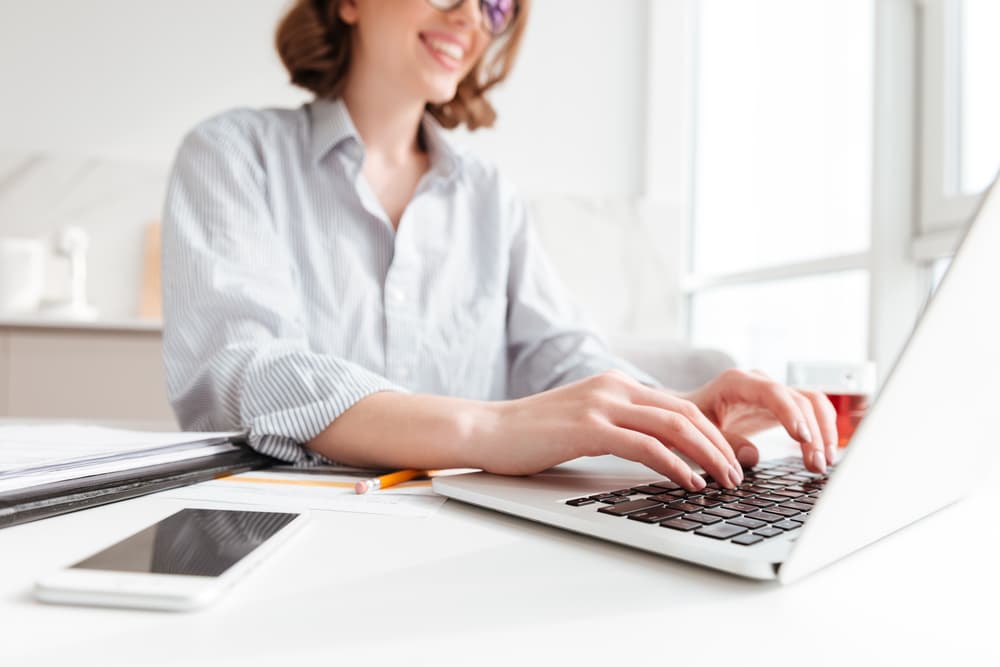 woman typing on her laptop