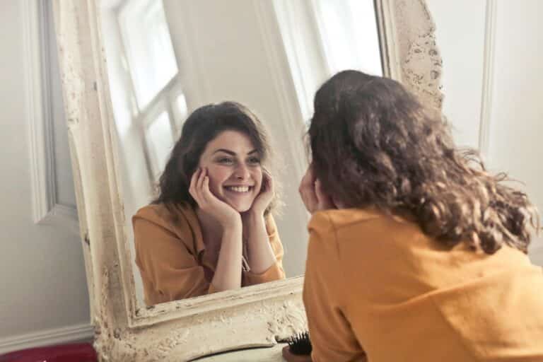 young-woman-looking-at-herself-in-mirror