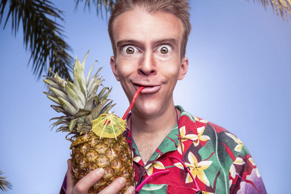 man drinking a pineapple beverage