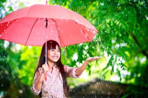 Young girl with a pink umbrella