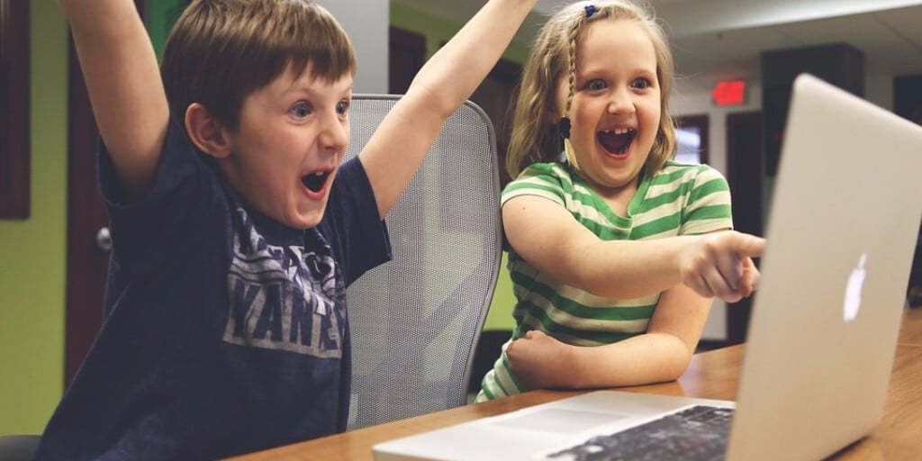 two kids playing computer games