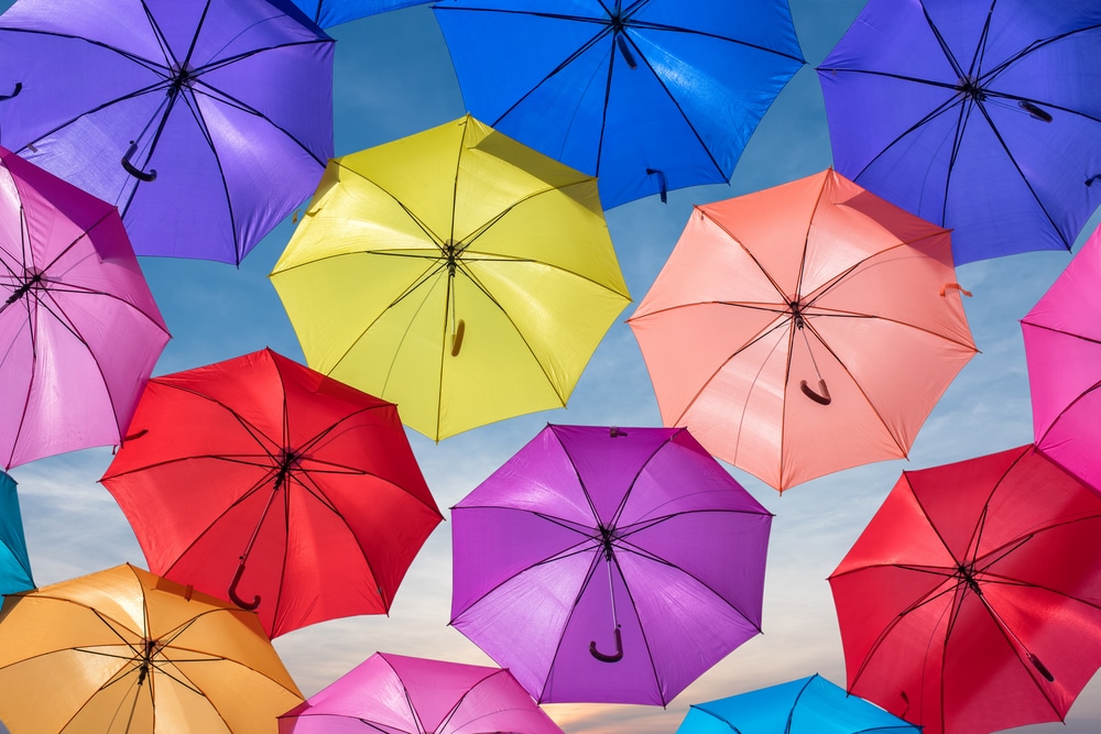 a bunch of colorful open umbrellas