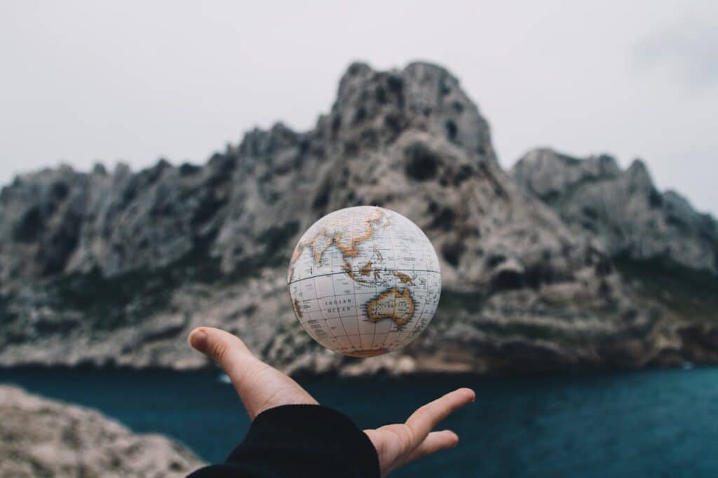 Open hand with a globe floating above