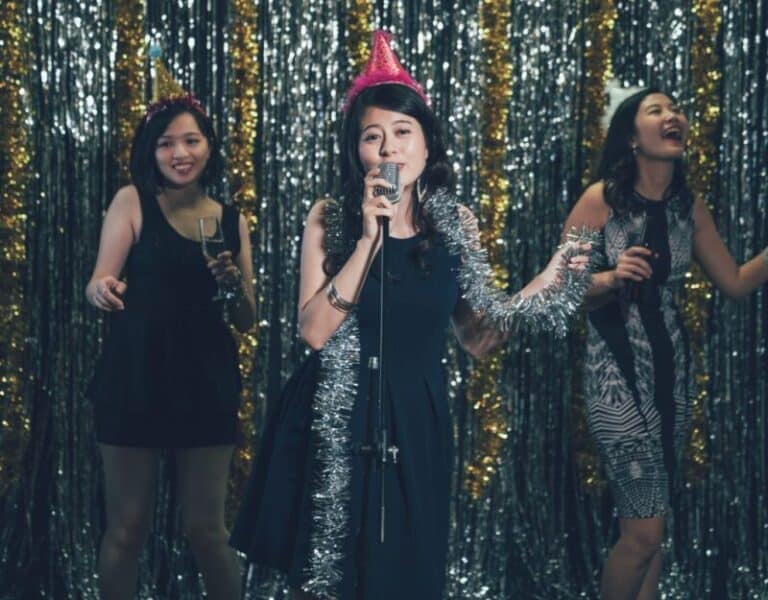 three women singing on stage