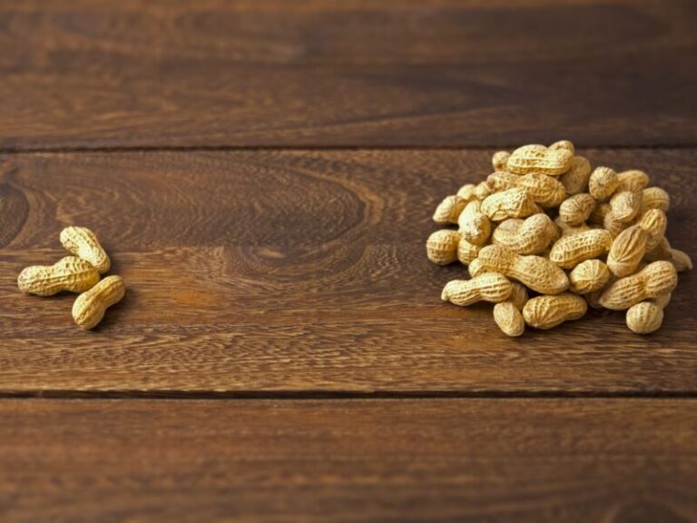 Three peanuts on the left and a big pile of peanuts on the right