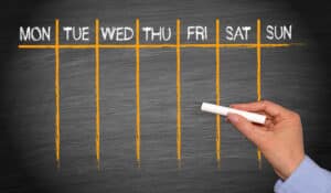 days of the week chart written on blackboard