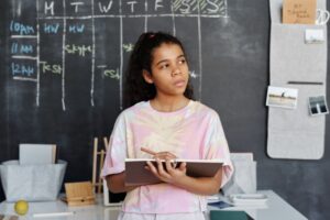 Photo by Julia M Cameron: https://www.pexels.com/photo/woman-in-pink-and-yellow-crew-neck-t-shirt-holding-brown-notebook-4143801/