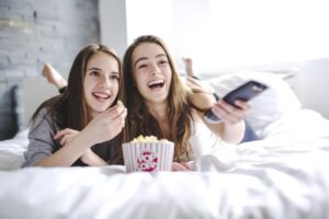 two-girls-watching-movie-at-home