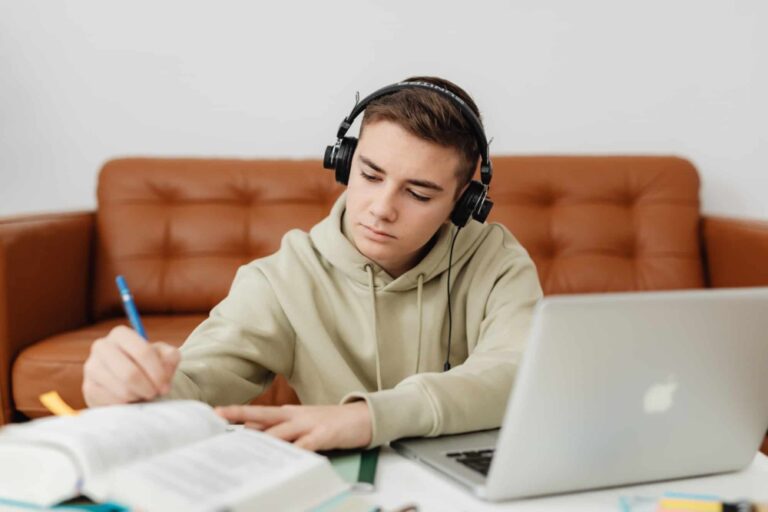 high-school-boy-studying-with-books-and-laptop