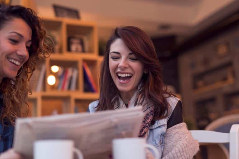 two-women-reading-a-newspaper