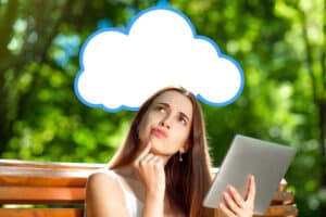 woman holding a tablet thinking with a speech bubble above her head