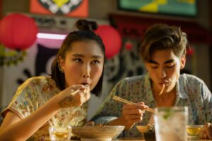 couple eating noodles at an outdoor restaurant