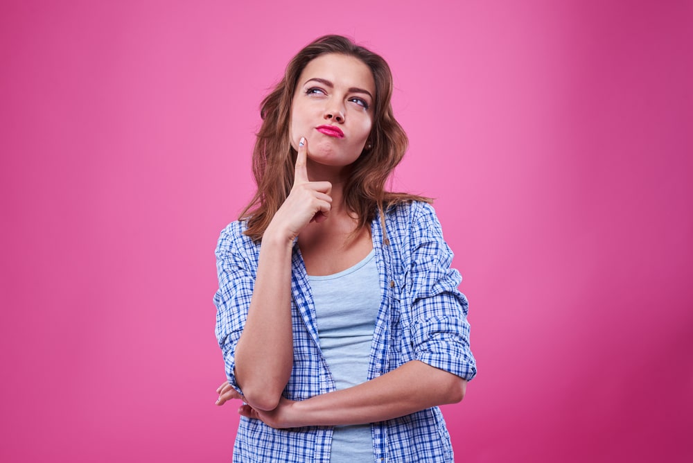 woman-thinking-with-hot-pink-background