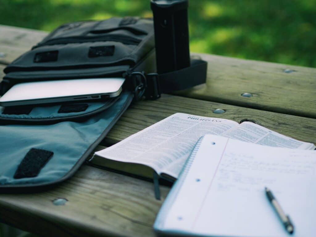 notebook and pen and book on a table