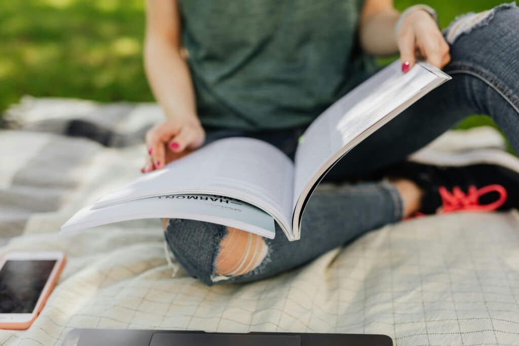 woman-sitting-outside-reading-book