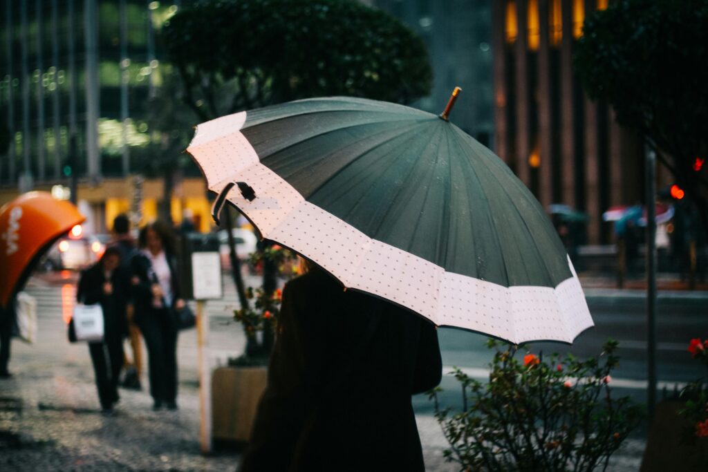 woman-holding-umbrella-on-city-street