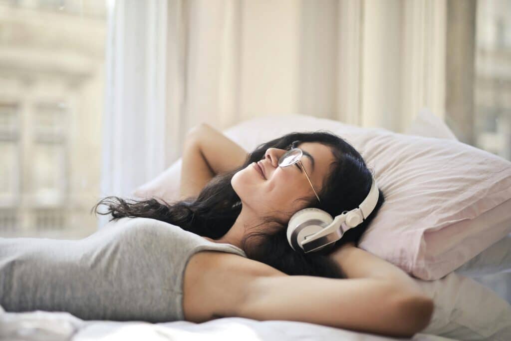 woman-listening-to-music-in-bed