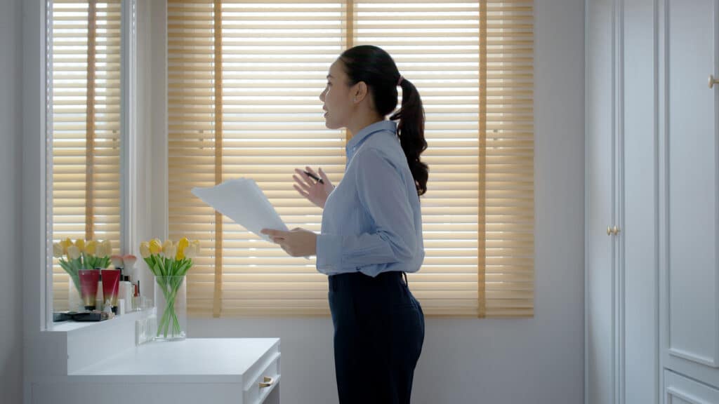 woman-practicing-presentation-in-mirror