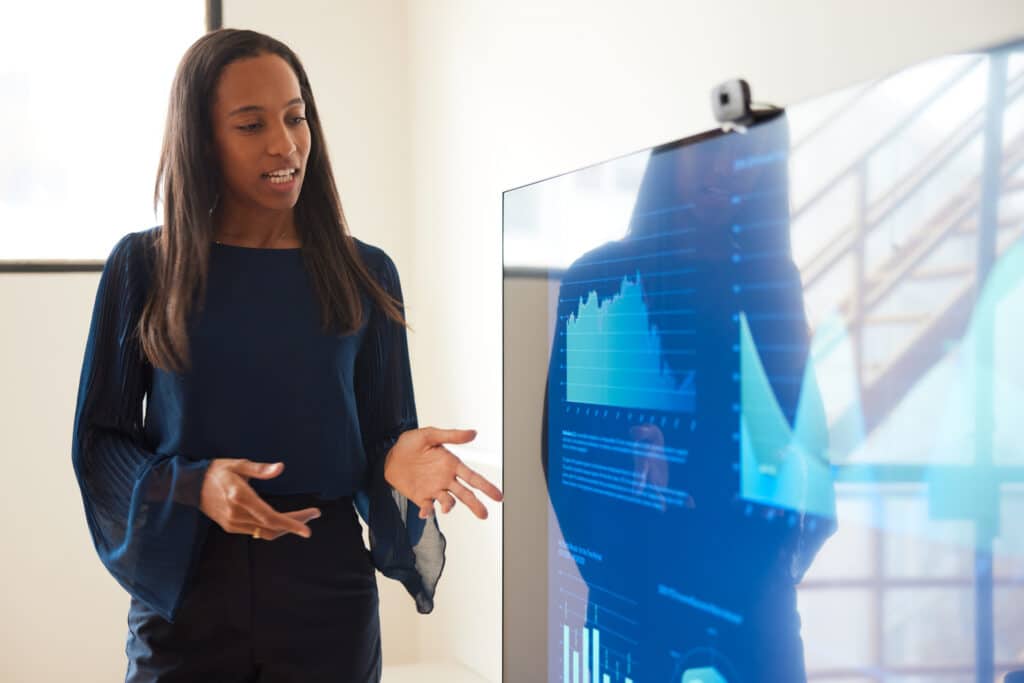 woman-presenting-chart-on-screen