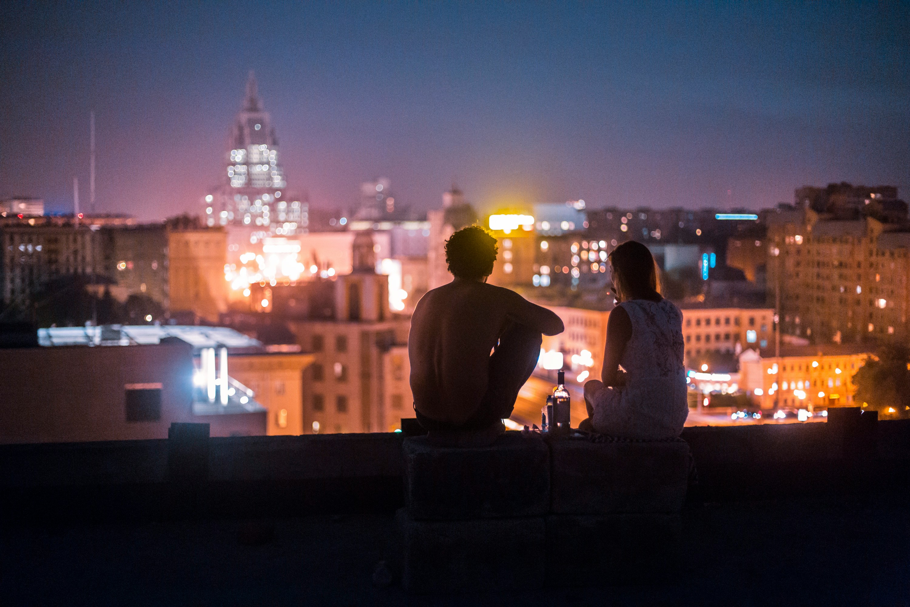 A young couple hangs out on a rooftop 