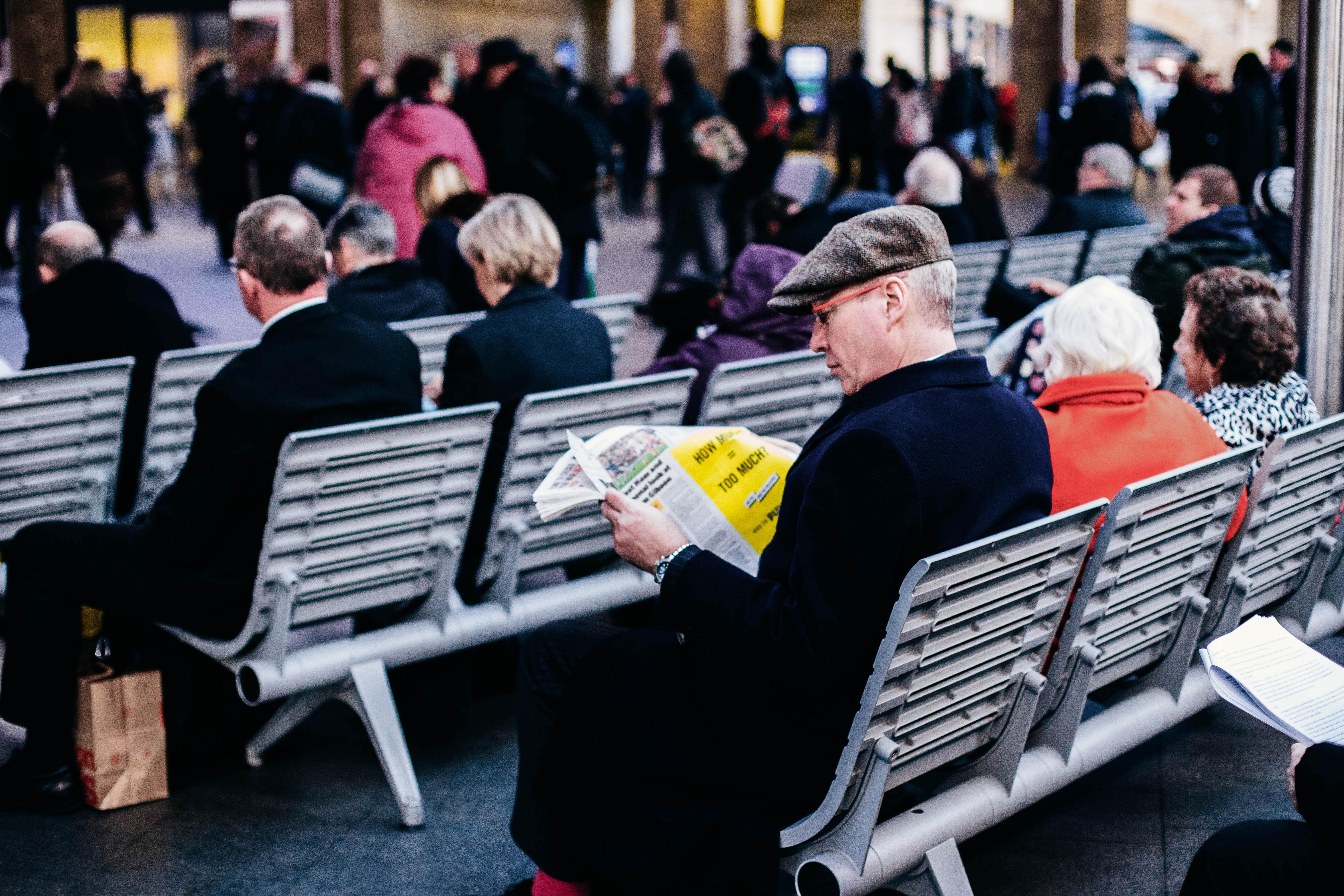 People sitting on benches in a train station