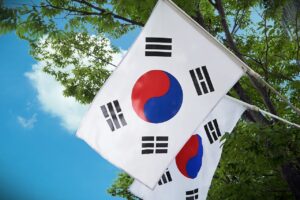 two korean flags on a sunny day