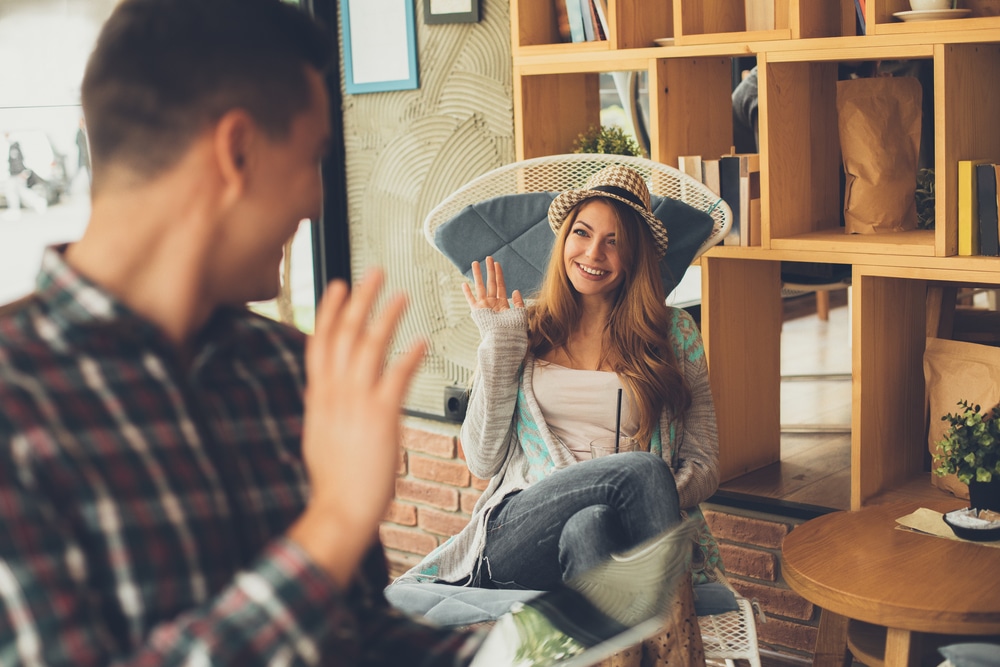 man-and-woman-waving-to-each-other