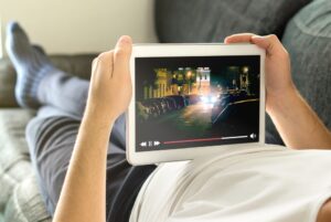 person streaming a movie on their tablet