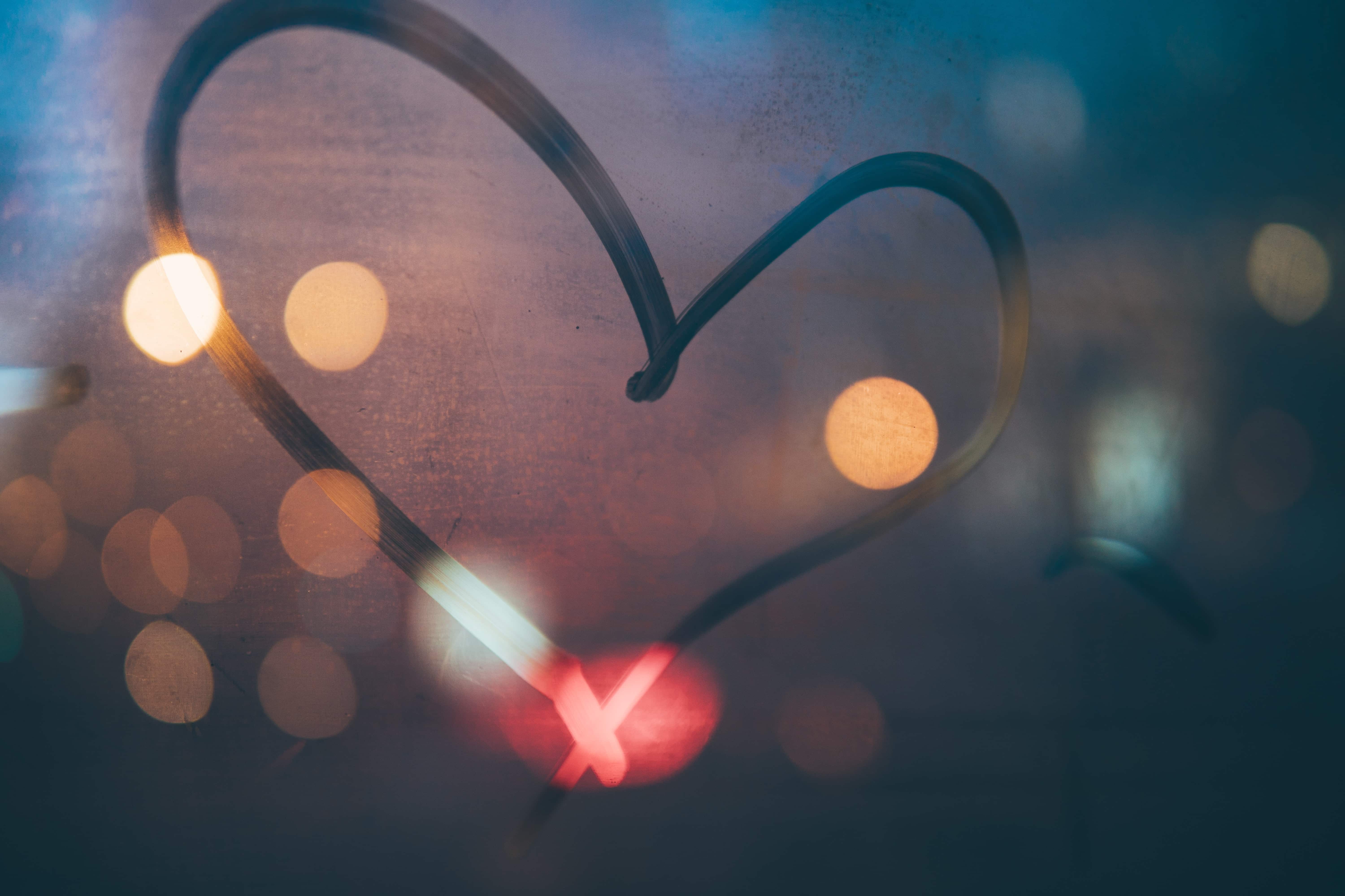 A heart drawn on a foggy window