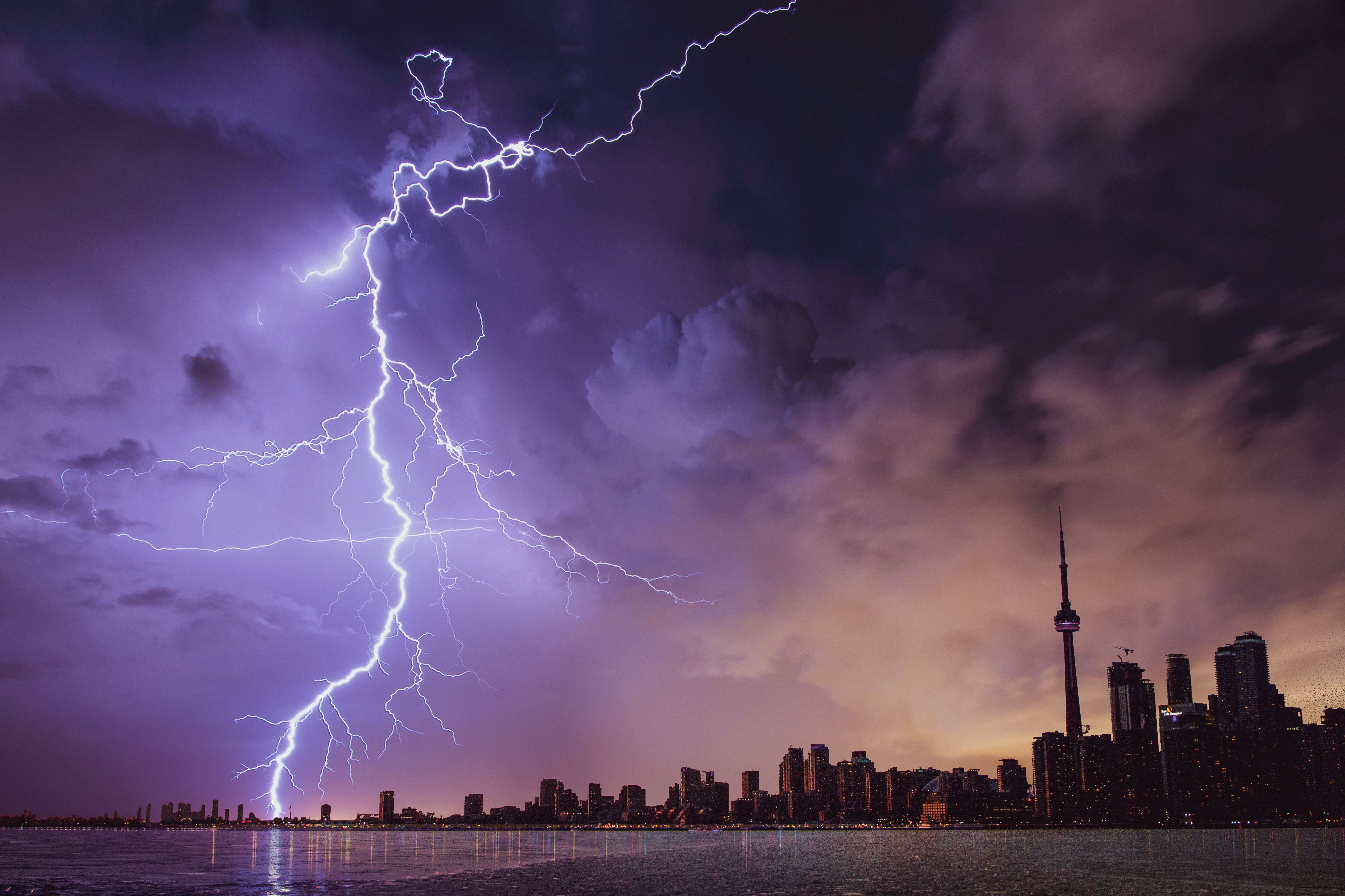 A stormy sky with lightning over a large city